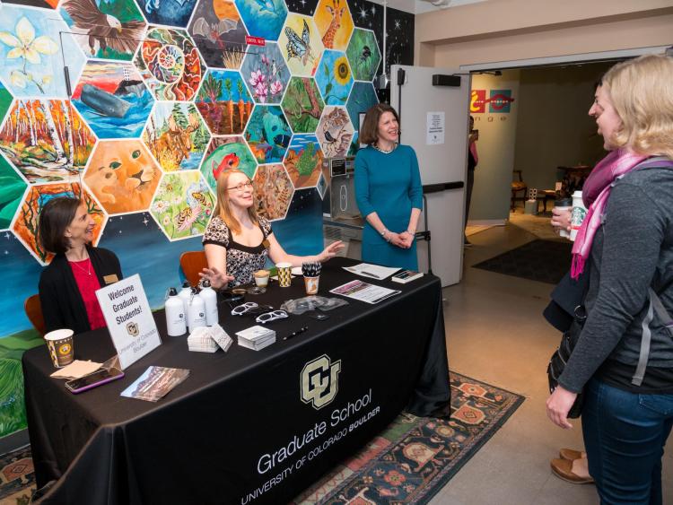 Graduate School Dean Ann Schmiesing and other staff welcome students to appreciation breakfast. Photo by Patrick Campbell.