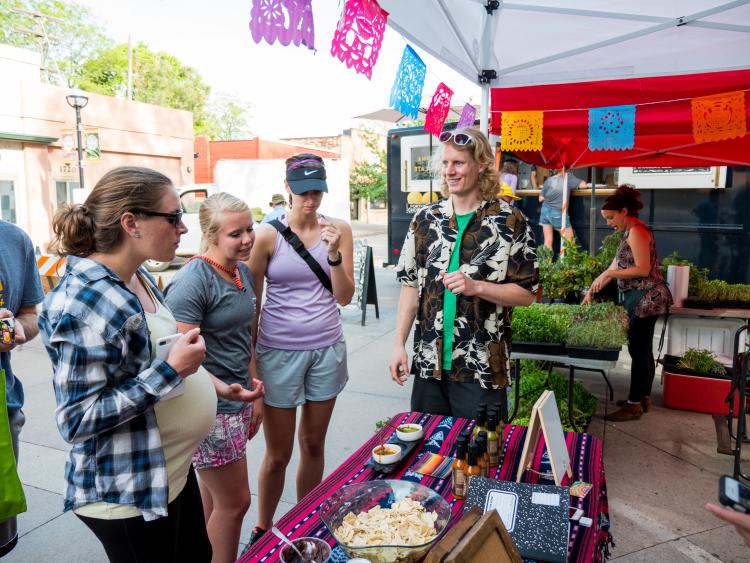 Charlie visits with customers at Boulder Farmer's Market