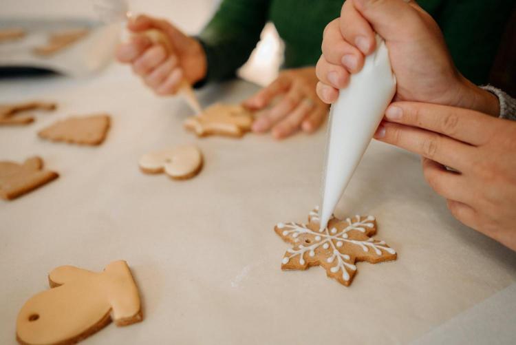 people decorating holiday cookies