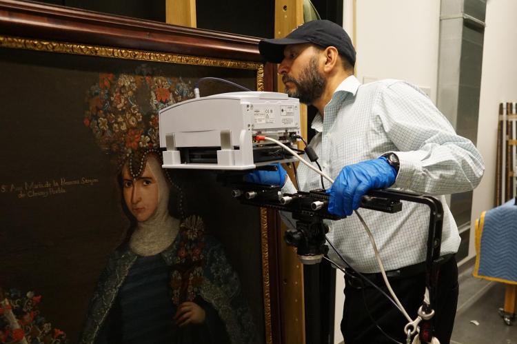Gerardo Gutiérrez runs a scan on a Renaissance-era portrait of a nun.