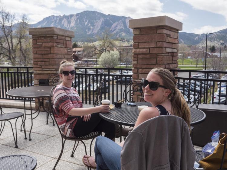 Third-year law students Yolanda Clarke, left, and Hannah Oaks, enjoy their last few days of class on the deck of the Hearsay Cafe. Photo by Glenn Asakawa.