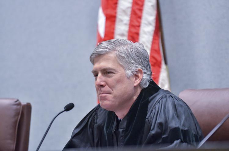 Neil Gorsuch sits at a courtroom bench. (Photo courtesy of Colorado Law.)