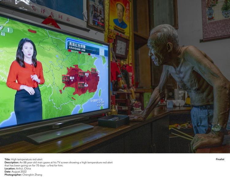 An 88-year-old man gazes at his TV screen showing a high temperature red-alert that has been going on for 70 days - a first for him.