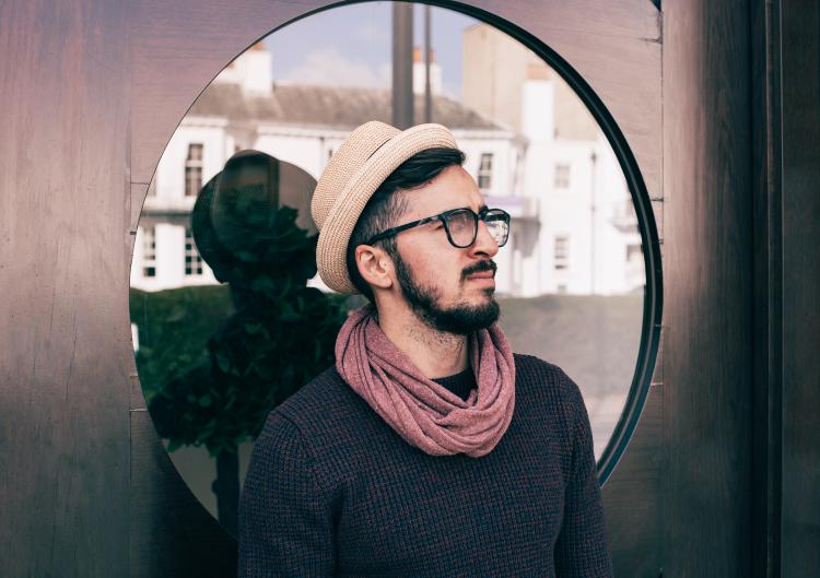 Man in brown fedora pauses to think