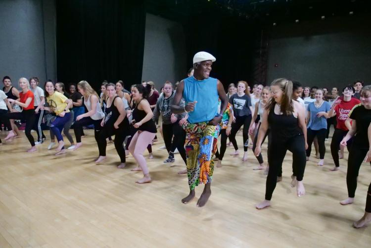 NiiAhmah Sowan leads high school students in African dance at the 2019 High School Dance Day at the CU Boulder campus. (Photo by Glenn Asakawa/University of Colorado)