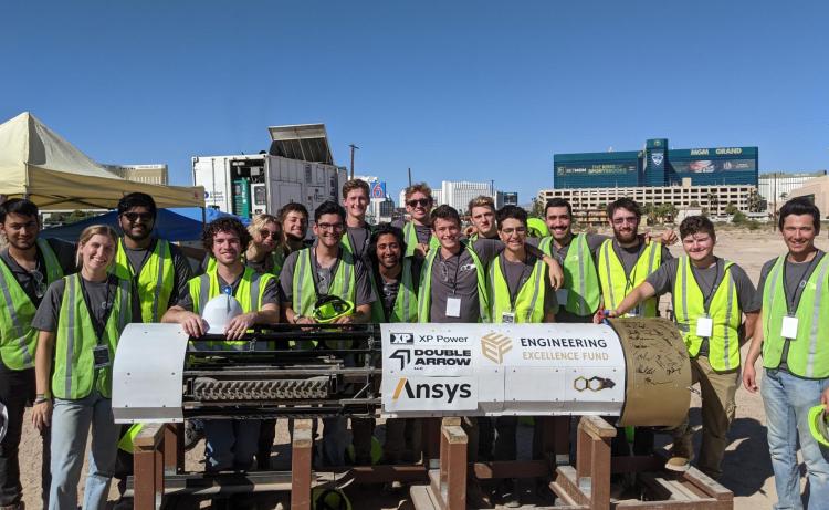 The CU Hyperloop teams poses with its boring machine in Las Vegas