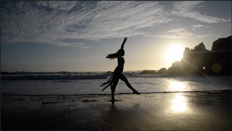 Rae Lewark performing on beach