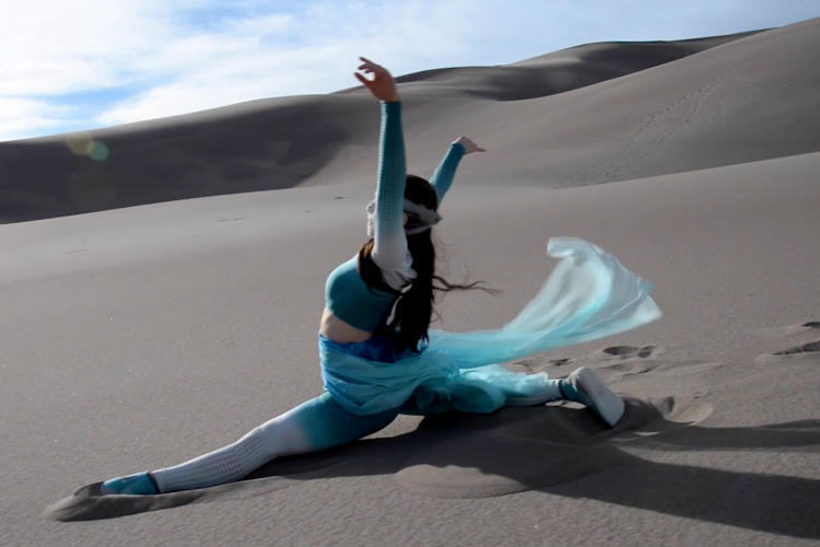 Rae Lewark performing in desert