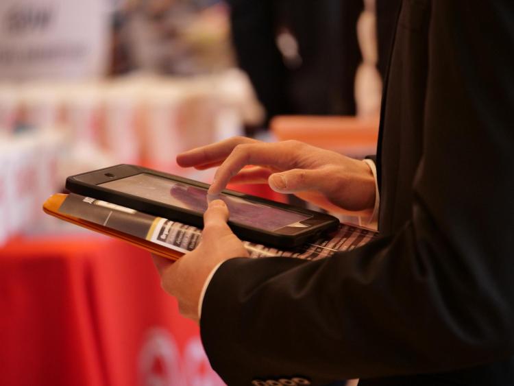 Many companies use technology to allow students to quickly enter their contact information at the Just in Time Career Fair. Photo by Glenn Asakawa.