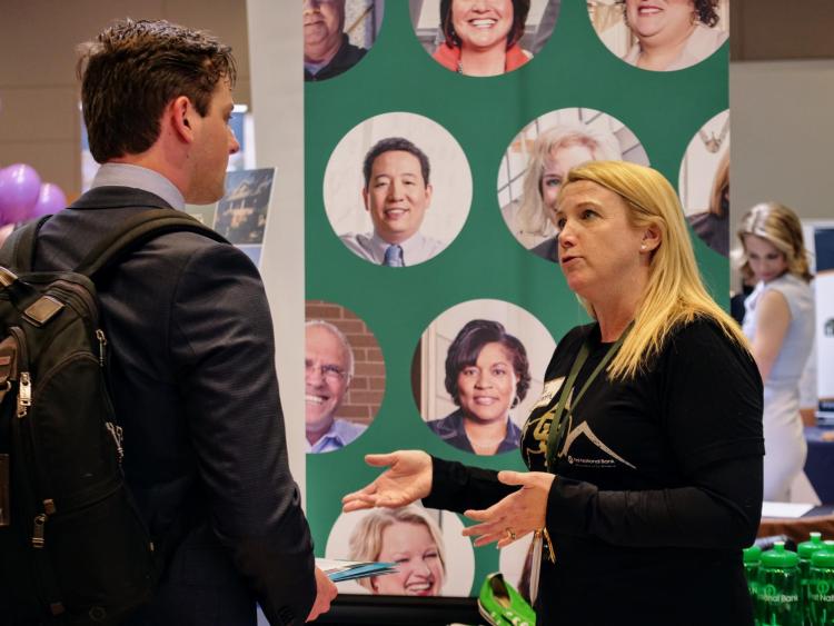 Recruiter speaks with finance student Michael Siegele. Photo by Glenn Asakawa.