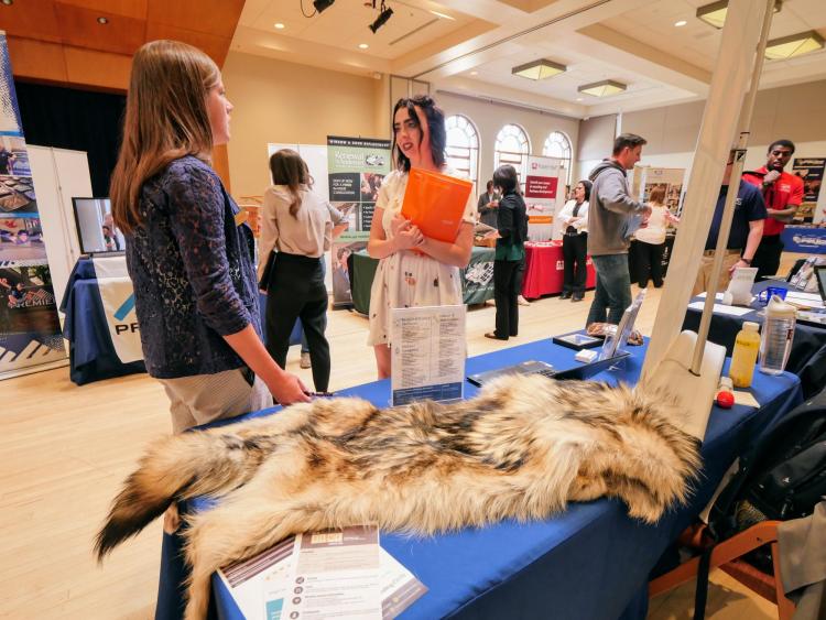 Hailey bond, ecology and evolutionary biology student, speaks with a U.S. Fish and Wildlife Service recruiter. Photo by Glenn Asakawa.