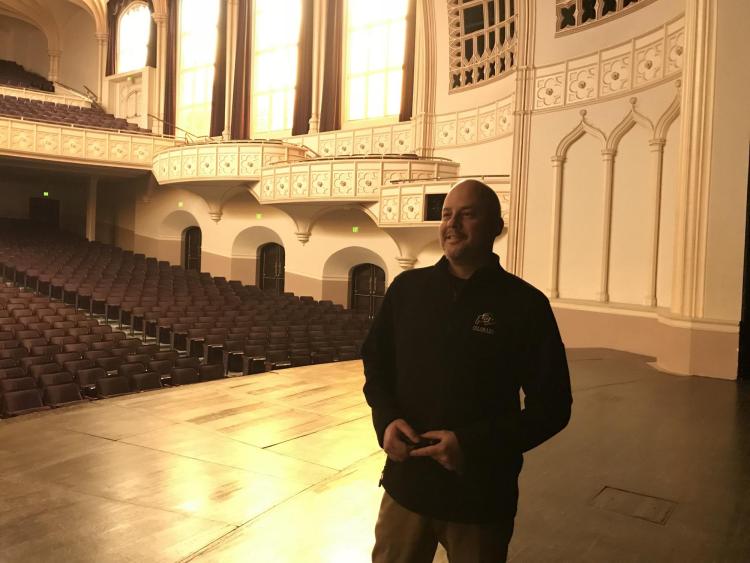 From Deb Mendez Wilson: Macky Director Rudy Betancourt poses in an empty concert hall during a recent staff tour.
