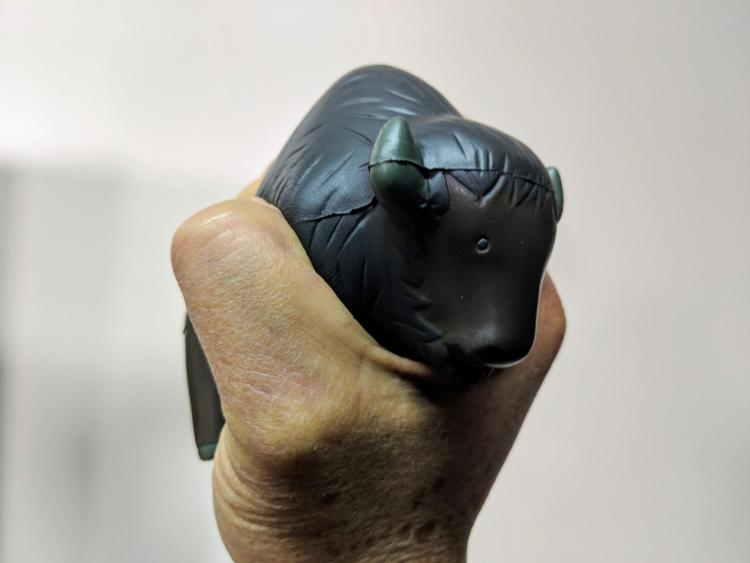 Person squeezes a Buff-shaped stress ball