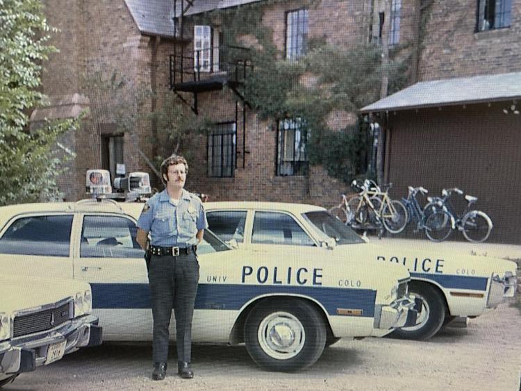 CUPD Officer Joe Armstrong with a late 1960s police car in front of the Armory