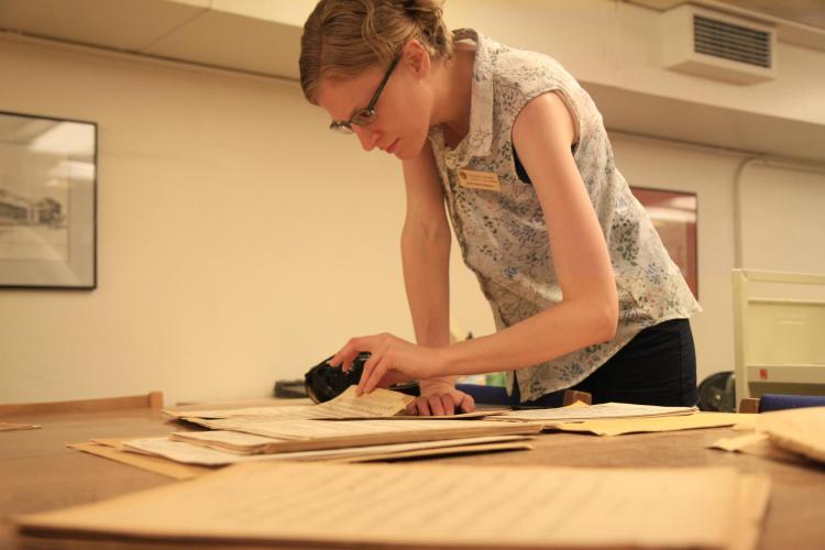 University Libraries staff member looks at a score