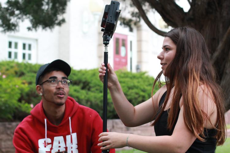 Nathaniel Nash and Rachel Boyce set up a light stand. (Photo courtesy of CMCI.)
