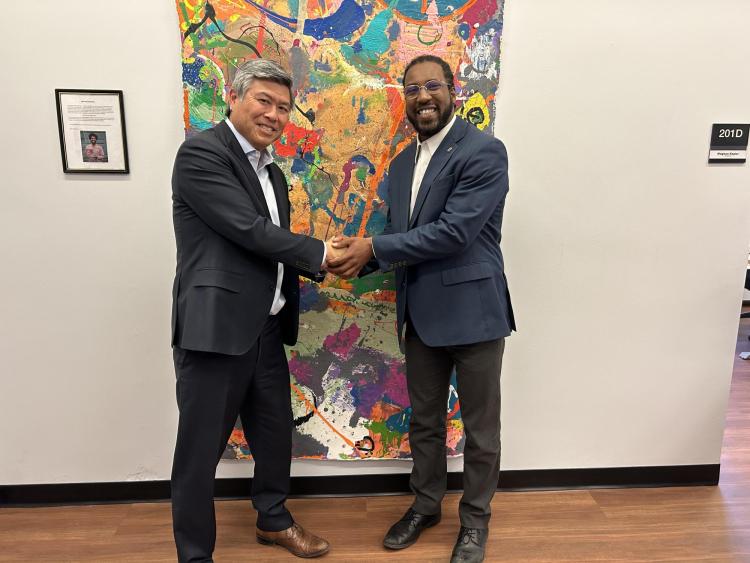 Daryl Maeda and artist DaMontá Madden in front of a painting.