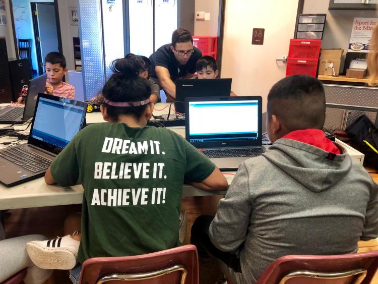 Students writing code
