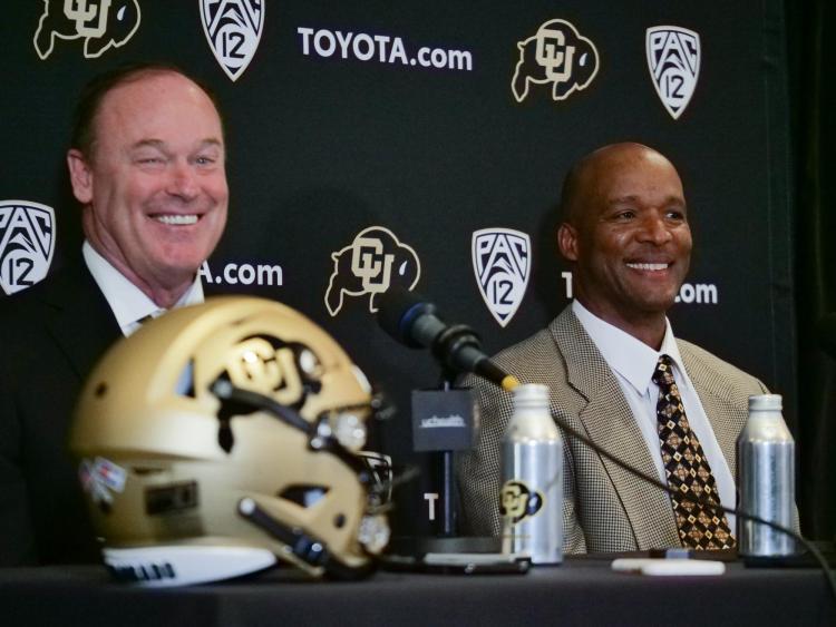 Athletic Director Rick George, left, and Karl Dorrell smile during a press conference announcing Dorrell as the new head football coach at CU Boulder. (Photo by Casey A. Cass/University of Colorado)