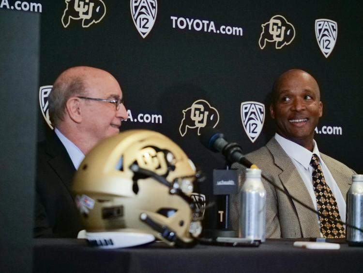 Chancellor Philip DiStefano, left, and Karl Dorrell smile during a press conference announcing Dorrell as the new head football coach at CU Boulder. (Photo by Casey A. Cass/University of Colorado)