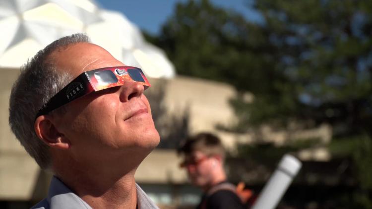 John Keller wearing eclipse glasses