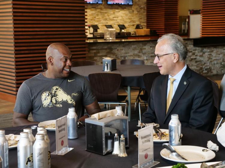 CU President Mark Kennedy, right, chats with CU Football head coach Mel Tucker during at tour of the athletics facilities and BioFrontiers Labs at the Jennie Smoly Caruthers Biotechnology Building. (Photo by Glenn Asakawa/University of Colorado)