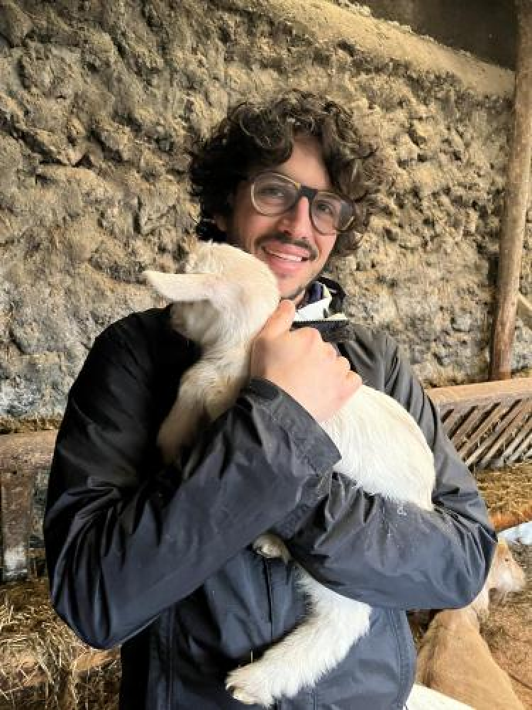 Zachary Kilpatrick holding a lamb in his arms