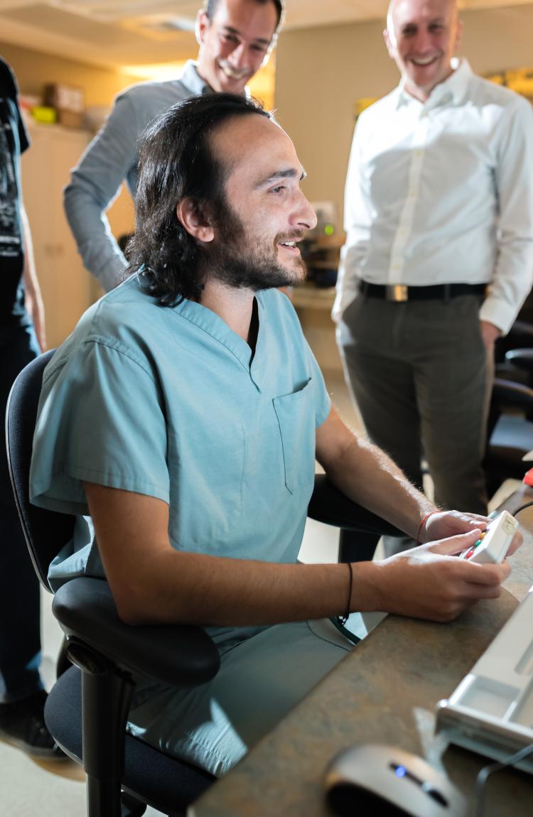 Davidi Kitai participates in research to be highlighted in a documentary while researchers look on. (Photo courtesy of Teryn S. Wilkes)