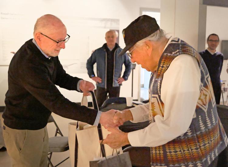 Two men shake hands