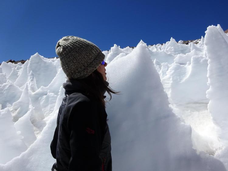 Lara Vimercati examines a nieves penitentes structure on Volcán Llullaillaco in Chile