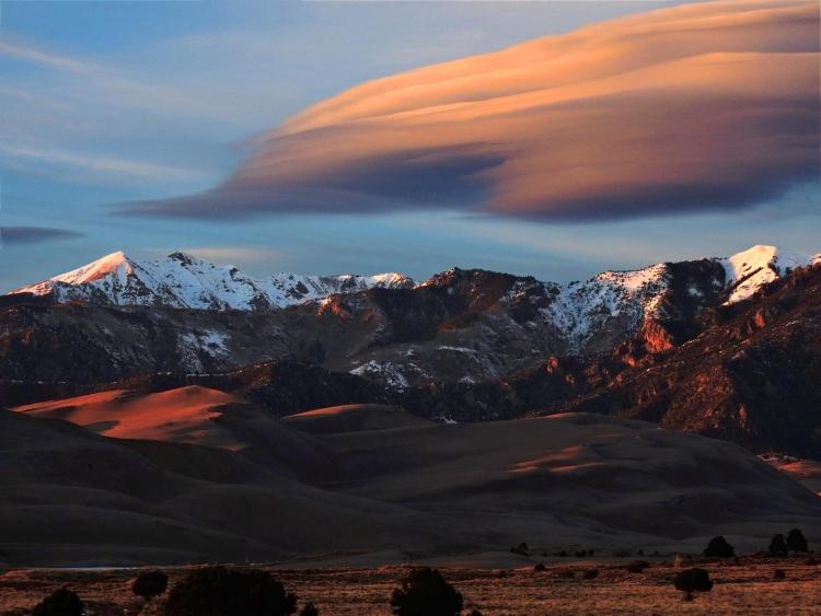Lenticular clouds, which look a bit like a layer cake, form over Great Sand Dunes National Park in Colorado.