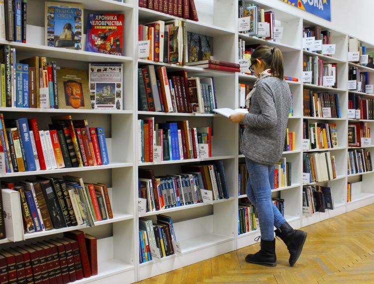 Woman peruses books at a library