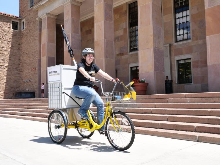 Woman on library bike in front of Norlin Library