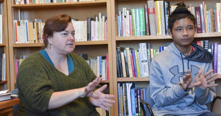Pamela Wright signs with Taw, an 18 year old high school student in Boulder
