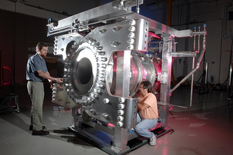 Eric Zimmerman (left) and a colleague work on a "magnetic horn," a device that helps the T2K experiment generate neutrino beams.