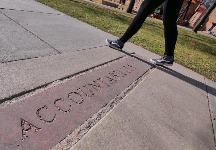 A Colorado Creed keyword is etched into sandstone on the sidewalk. Photo by Casey A. Cass.