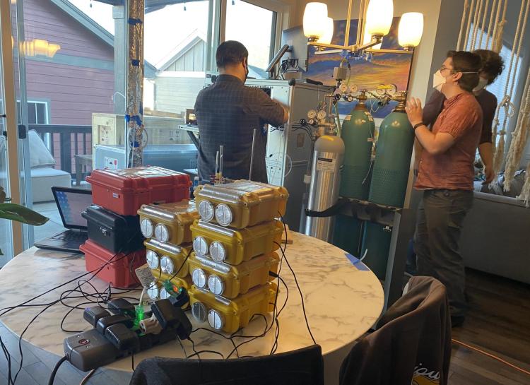 Researchers move around scientific equipment in home