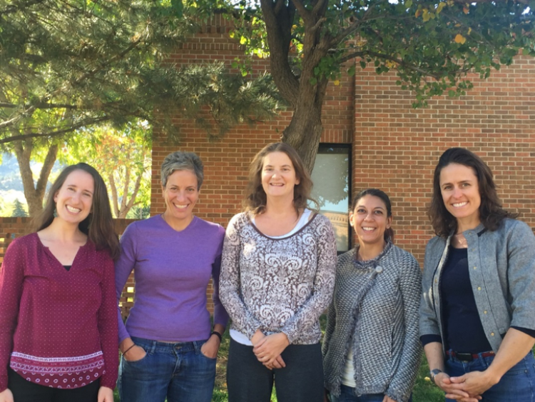 The team of grant recipients, five women from Mental Health Partners and CU Boulder, stand in a row and pose for a photo, smiling.