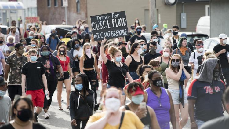 Protesters march down the street in Minneapolis.