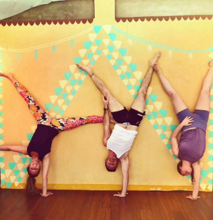 Miranda Viorst does a handstand with fellow classmates