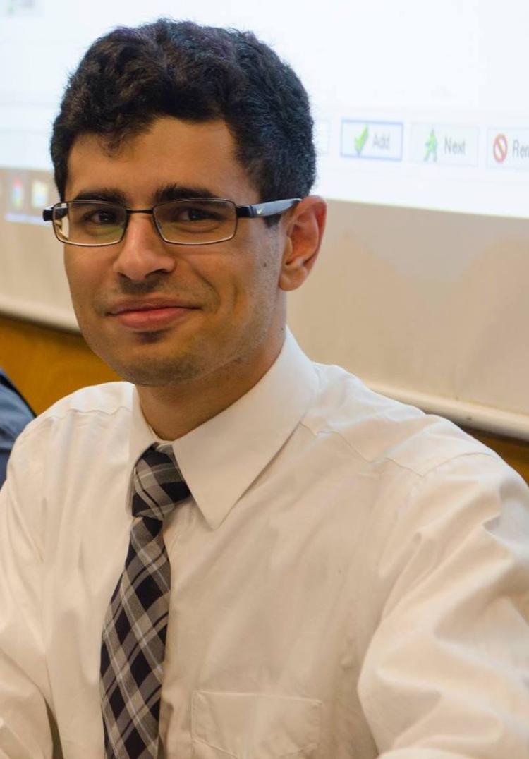 A portrait of Muntadher AlZayer in a white dress shirt.