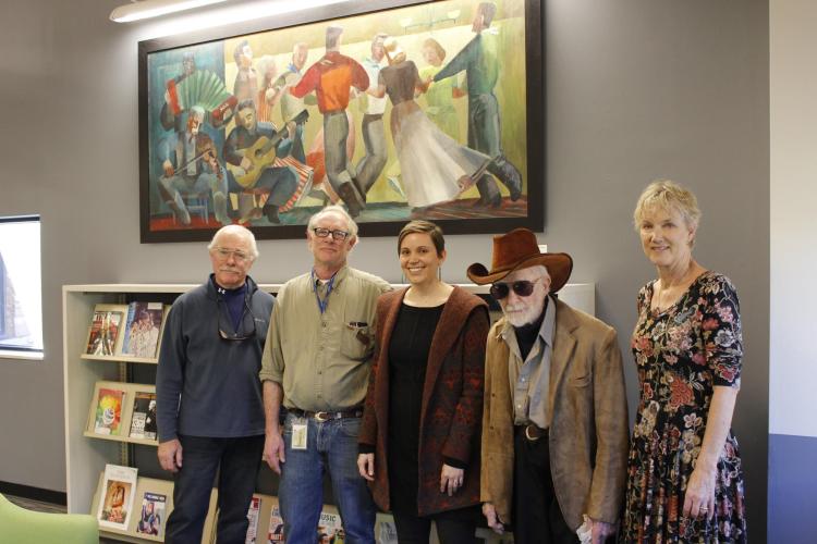 Centenarian artist Lynn Wolfe (fourth from the right) came to see his artwork in the re-opened music library. Also pictured are Stephanie Bonjack, Carl Stewart and two of Wolfe’s relatives. Photo courtesy of University Libraries.