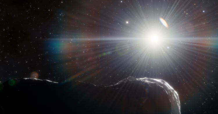 asteroid covered in shadows with sun in the background