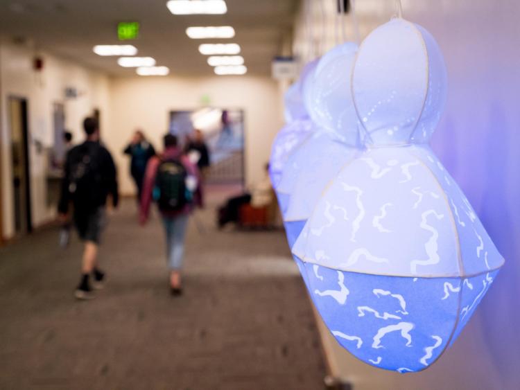 An interactive light exhibit hanging in the halls of Norlin Library. Photo by Patrick Campbell.