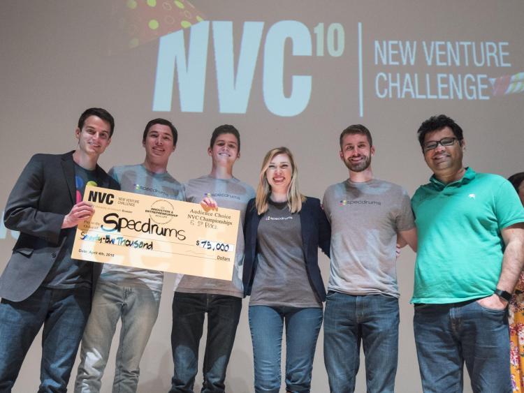 Specdrum team members hold their first place check for $75,000. Photo by Glenn Asakawa.