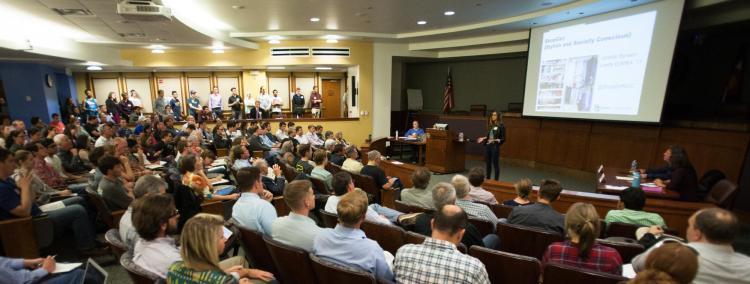 A member pitches to a crowd at a New Venture Challenge event.