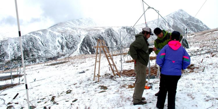 Three research collect data on a snowy Niwot Ridge.