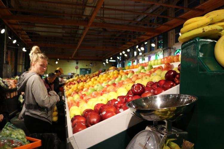 People shopping for produce in a grocery store