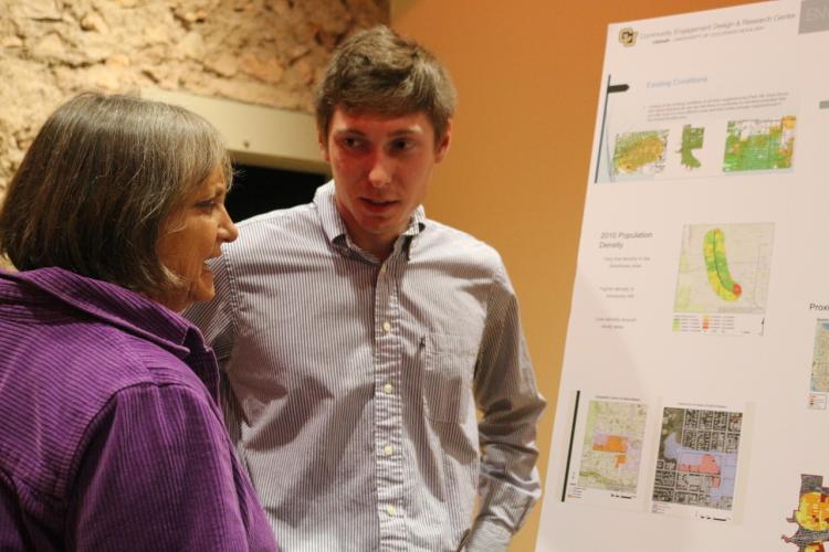 Reese Shaw explains his Alpine-Balsam research to a community member