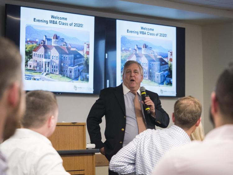 Leeds School of Business Associate Dean Michael Caplan welcomes the Evening MBA class of 2020 at an orientation. Photo by Glenn Asakawa.